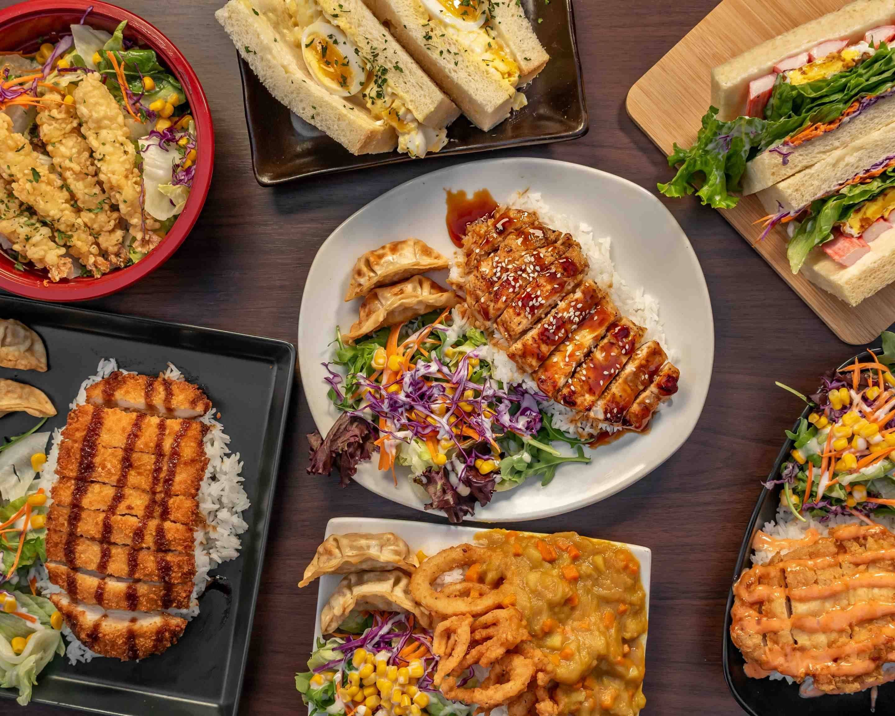 Mushi Japanese Food and More decorative image of Japanese food on a table.